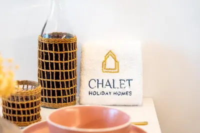 a bottle of wine and a cup on a table at Luxurious New Studio! 2 Double Beds! Sleek Design & High-End Amenities in Dubai Downtown in Dubai