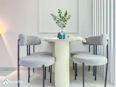 a white table with two chairs and a vase on it at Amazing New Design Flat with Rooftop Pool in Dubai Marina 5 pax in Dubai
