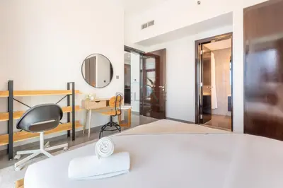 a bedroom with a bed and a desk and a mirror at 2BR Near Burj Khalifa & Business Bay Metro Station, Merano Tower, Business Bay in Dubai