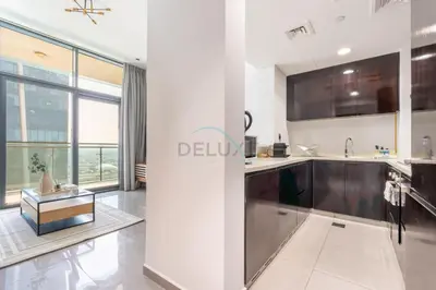 a kitchen with stainless steel appliances and a large window at 2BR Near Burj Khalifa & Business Bay Metro Station, Merano Tower, Business Bay in Dubai