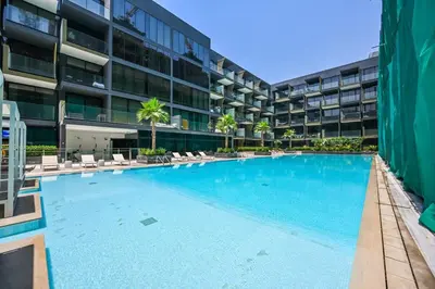 a large swimming pool in front of a building at Stunning 1 br modern luxury residence at JVC in Dubai