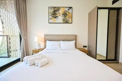 a bedroom with a large white bed and a window at Stunning 1 br modern luxury residence at JVC in Dubai