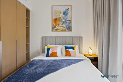 a bedroom with a large bed with colorful pillows at Urban Glam 1 BR in Surf 2-Creek Beach Access in Dubai