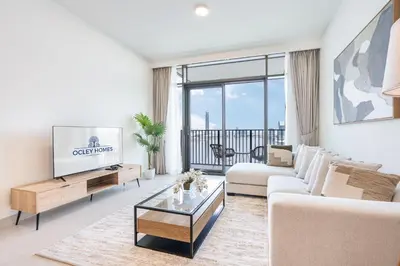 a living room with a couch and a tv at Brand New Creek Home with Panoramic Water View in Dubai