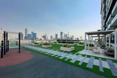 a rooftop of a building with a view of a city at Stylish 1BR Apartment in Binghatti Onyx JVC in Dubai