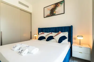 a bedroom with a large white bed with pillows at Full Burj Khalifa and Fountain View from All Rooms in Dubai