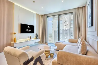 a living room with a couch and a tv at STAY BY LATINEM Luxury 1BR Holiday Home CVG 3204 Near Burj Khalifa in Dubai