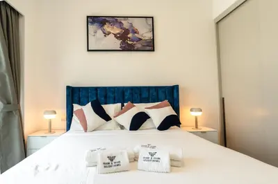 a bedroom with a large white bed with pillows at Burj & Fountain View Retreat in Dubai