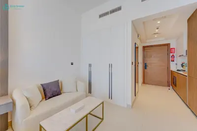 a living room with a couch and a table at Bright & Luxury Studio with Balcony in Al Furjan in Dubai