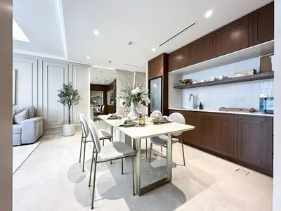 a kitchen and dining room with a table and chairs at Seaside Elegance 1BR Luxury Apartment with Private Beach Access, Emaar Beachfront in Dubai