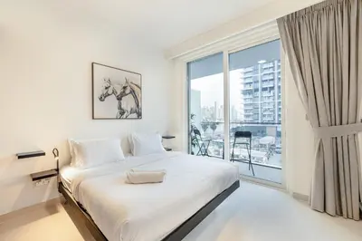 a bedroom with a bed and a large window at ALiving Classy 1BR I Stunning Views I Emaar Palace Beach Residence in Dubai