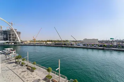 a view of a river with a roller coaster at 2BR Canal Front B3, Waterfront Views in Dubai