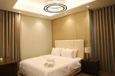 a bedroom with a bed with two speakers on it at Brand New Large 2 Bedroom with Burj Khalifa view in Dubai