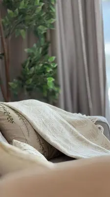 a pillow sitting on a bed under a blanket at One bedroom Full view Dubai Hills in Dubai
