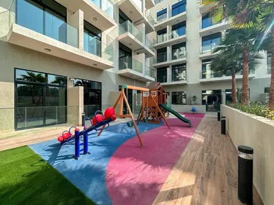 a playground in the courtyard of a building at Holiday Boulevard - Stylish Upgraded Studio - Designer Touches in JVC in Dubai