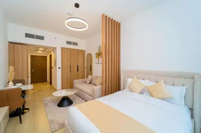 a hotel room with a bed and a living room at Elegant JVC Stay Luxury Amid Nature in Dubai