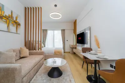 a living room with a couch and a table at Elegant JVC Stay Luxury Amid Nature in Dubai