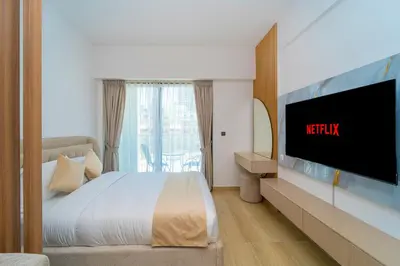 a hotel room with a bed and a tv at Elegant JVC Stay Luxury Amid Nature in Dubai