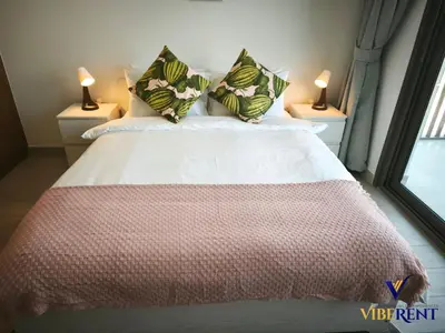 a bedroom with a large bed with two lamps at 2BR Sofa Bed Sleep 6 Furjan in Dubai
