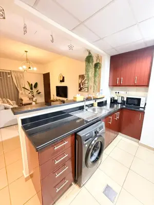 a kitchen with a washer and dryer in it at Beachside Spacious Studio at the heart of JBR in Dubai
