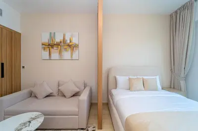 a bedroom with a couch and a bed at Luxurious Nature with 5 Star Amenities in JVC in Dubai