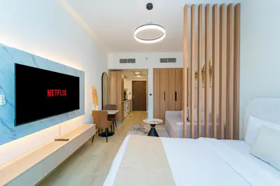 a hotel room with a tv on the wall at Luxurious Nature with 5 Star Amenities in JVC in Dubai