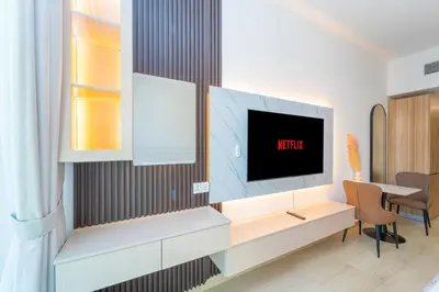 a living room with a tv on a wall at Luxurious Nature with 5 Star Amenities in JVC in Dubai