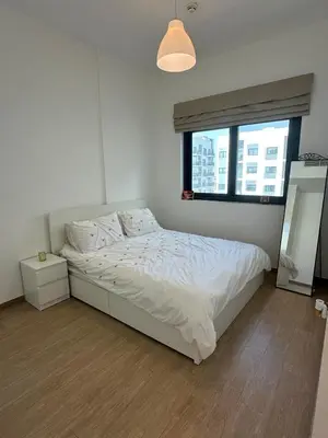 a white bedroom with a bed with a window at The Nook 2 - 2 bed flat near Dubai Marina in Dubai