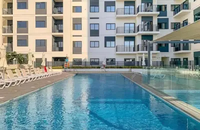 a swimming pool in front of a building at The Nook 2 - 2 bed flat near Dubai Marina in Dubai