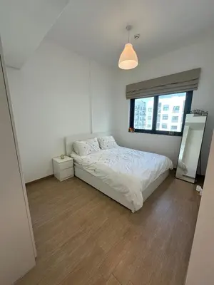 a white bedroom with a bed and a window at The Nook 2 - 2 bed flat near Dubai Marina in Dubai