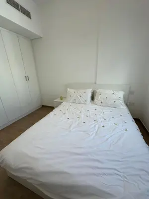 a large white bed in a white bedroom at The Nook 2 - 2 bed flat near Dubai Marina in Dubai