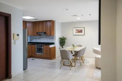 a kitchen and dining room with a table and chairs at 13P-Sea View Apartment in Dubai Marina with Pool & Balcony in Dubai