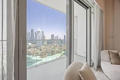 a room with a large window with a view of the city at Elite Escapes - 2 BHK Luxurious - Grande Signature in Dubai