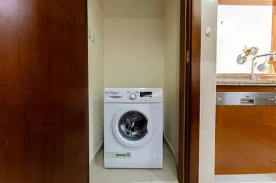 a washer and dryer in a small room at Stand Point Residence by Hogar in Dubai