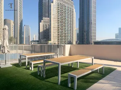 three benches on a rooftop with a view of a city at Swanky Suite Forte T1 2BR Downtown in Dubai