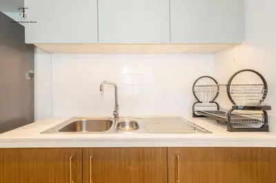 a kitchen counter with a sink and two baskets at Swanky Suite Forte T1 2BR Downtown in Dubai