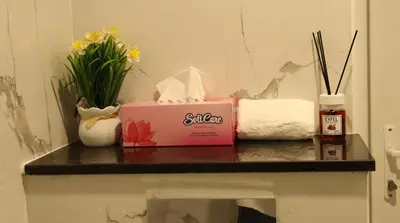 a table with a box and flowers on it at 1BHK Holiday Location in Dubai