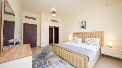 a bedroom with a bed and a desk and a chair at Luxury Casa - Paramount Sea View Apartment 2BR in Dubai