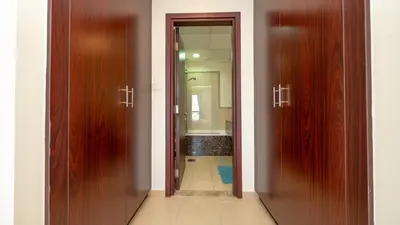 a hallway with two wooden doors and a bathroom at Luxury Casa - Paramount Sea View Apartment 2BR in Dubai