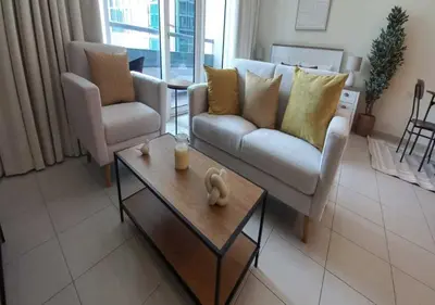 a living room with two couches and a coffee table at Bay Square studio Bay view in Dubai
