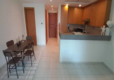 a kitchen and dining room with a table and chairs at Bay Square studio Bay view in Dubai