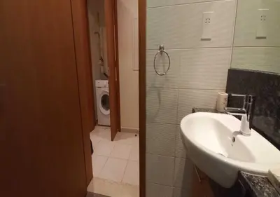 a bathroom with a sink and a toilet at Bay Square studio Bay view in Dubai