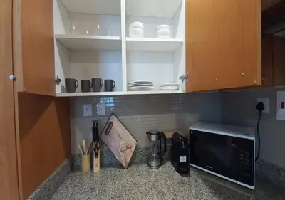 a kitchen with a counter with a microwave and a counter top at Bay Square studio Bay view in Dubai