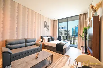a living room with a couch and a bed at New Studio In Arjan by Deleguest in Dubai