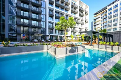 a swimming pool in front of a building at Modern Studio in Arjan by Deleguest in Dubai
