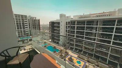 a view from the balcony of a building with a pool at Relaxing Retreat in Meydan in Dubai
