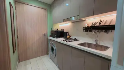 a kitchen with a sink and a washing machine at Relaxing Retreat in Meydan in Dubai