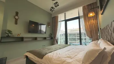 a bedroom with a bed and a large window at Relaxing Retreat in Meydan in Dubai