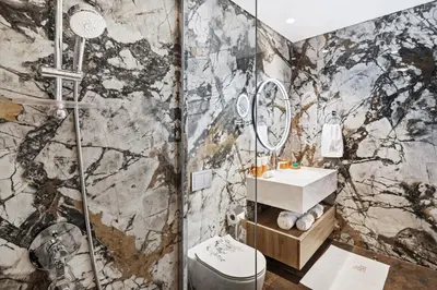 a bathroom with a shower and a sink at Lagoon Charm Luxurious Waterfront Living in Dubai