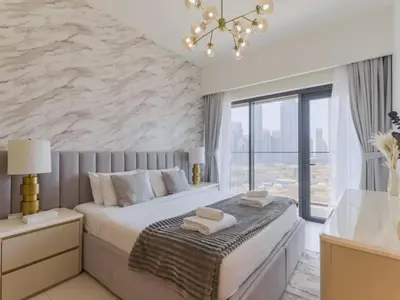 a bedroom with a large bed and a stone wall at TRPS - Burj Royale, Downtown Dubai - 2BR - Burj Khalifa View - Furnished & Ready in Dubai